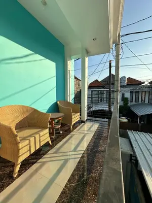 a patio with chairs and a table on a building at House Jimbaran Kuta 3 bedroom 8 pax SukaBali 6 in Jimbaran