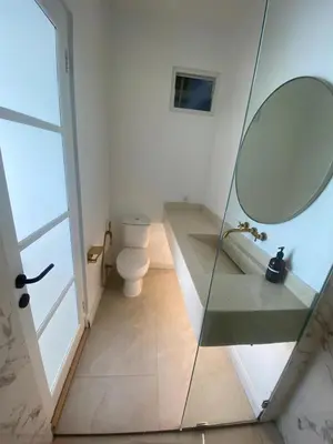 a bathroom with a glass shower and a toilet at Ara Santvana Villa Bali in Legian