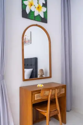 a dressing table with a mirror and a chair at Villa Bali Road House Seminyak in Seminyak