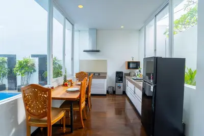 a kitchen and dining room with a table and chairs at Villa Bali Road House Seminyak in Seminyak