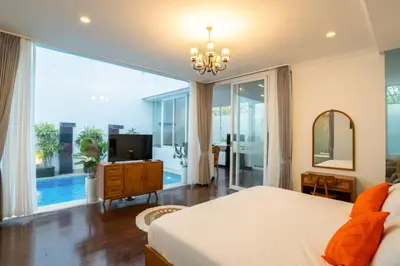a bedroom with a bed and a large window at Villa Bali Road House Seminyak in Seminyak