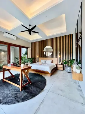 a bedroom with a large bed and a table at 2 BR Villa Near Seminyak Beach in Seminyak
