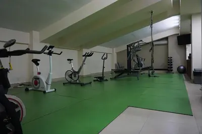 a gym with bikes and exercise equipment in a room at Peninsula Bay Resort in Nusa Dua