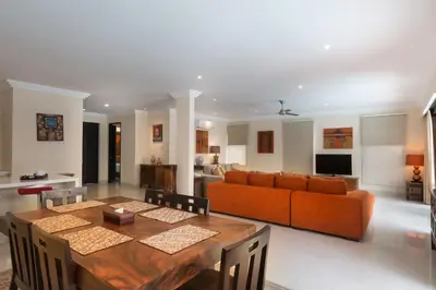a living room with a table and a couch at Peninsula Bay Resort in Nusa Dua
