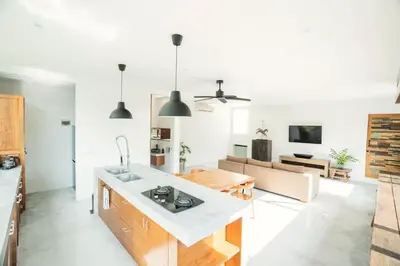 a kitchen and living room with a couch and a table at Villa Sassy - Stunning Private Award Winning Seminyak Oasis in Seminyak