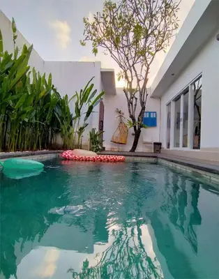 a swimming pool in the middle of a house at Bluna Villa seminyak in Seminyak