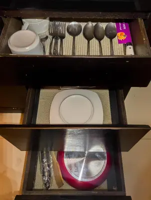 a shelf with utensils on top of a table at The Mupu Seminyak in Seminyak