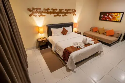 a hotel room with a bed and a couch at The Mupu Seminyak in Seminyak