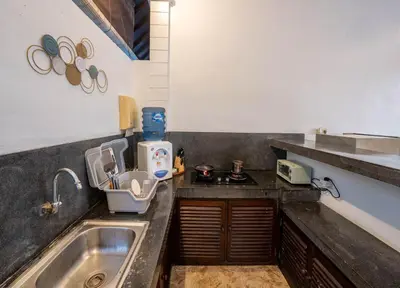a kitchen with a sink and a counter top at The Mupu Villa Seminyak in Seminyak