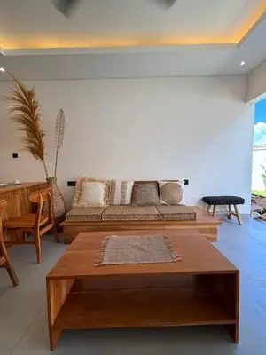 a living room with a couch and a table at Villa Taoro Jimbaran in Jimbaran