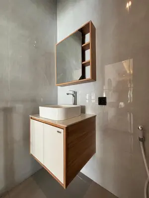 a bathroom with a sink and a mirror at Villa Taoro Jimbaran in Jimbaran