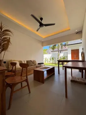 a living room with a ceiling fan and a couch at Villa Taoro Jimbaran in Jimbaran
