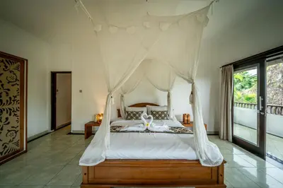 a bedroom with a bed with a canopy at Villa Panda Seminyak next to KU DE TA Beach Club in Seminyak