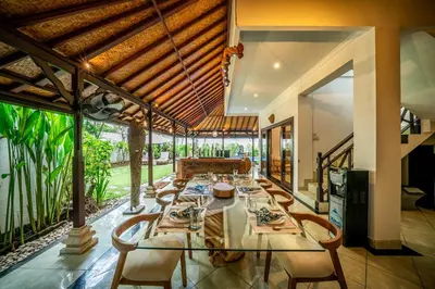 a dining room with a long table and chairs at Villa Panda Seminyak next to KU DE TA Beach Club in Seminyak