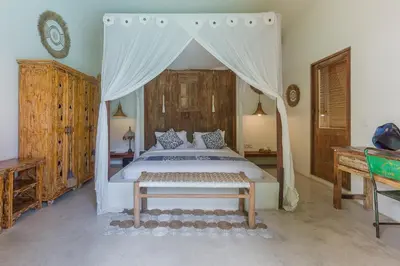 a bedroom with a bed with a canopy at Luxury 3BR Villa Daenerys Pool Ricefield Family-Friendly Near Canggu in Kerobokan