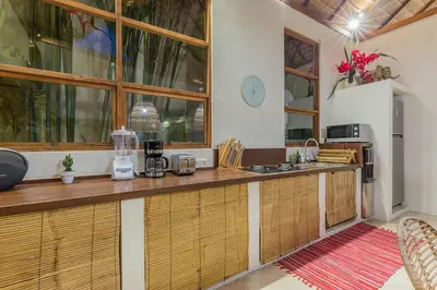 a kitchen with a counter and a counter top at Luxury 3BR Villa Daenerys Pool Ricefield Family-Friendly Near Canggu in Kerobokan