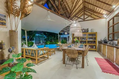 a kitchen and dining room with a table and chairs at Luxury 3BR Villa Daenerys Pool Ricefield Family-Friendly Near Canggu in Kerobokan