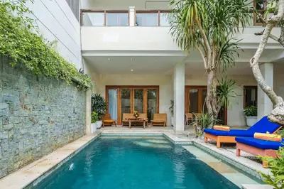 a swimming pool in a backyard with a house at Villa Orange 2BR Seminyak by Exotic Bali Properties in Badung