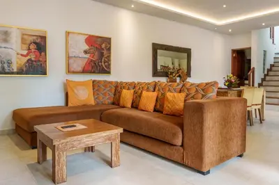 a living room with a brown couch and a table at Villa Orange 2BR Seminyak by Exotic Bali Properties in Badung