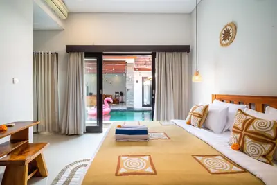 a bedroom with a large bed in a room at Villa O'Anne II in Seminyak