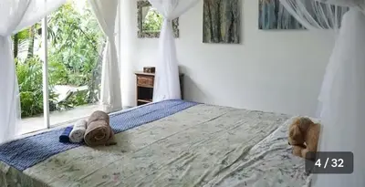 a bedroom with a bed with a teddy bear on it at Jimbaran room 01 in Jimbaran
