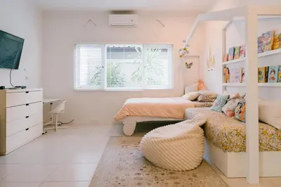 a bedroom with a bed and a bed and a couch at Villa Kubu Lebak 3 in Seminyak