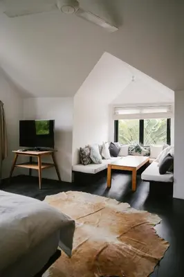 a room with a bed and a couch and a tv at Villa Kubu Lebak 3 in Seminyak