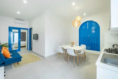 a kitchen and dining room with a table and chairs at Casa Posa Seminyak in Seminyak