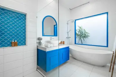 a bathroom with a tub and a sink at Casa Posa Seminyak in Seminyak