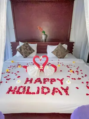 a bed with a happy birthday sign on it at Classic Villa with Private Pool in Kuta