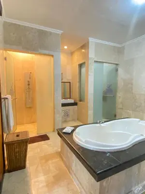 a large bathroom with a tub and a shower at Classic Villa with Private Pool in Kuta