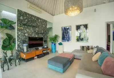 a living room with a couch and a flat screen tv at Bali Modern Escape With Private Pool, 8 guests in Kerobokan