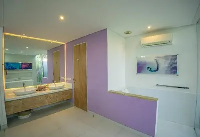 a bathroom with two sinks and a purple wall at Bali Modern Escape With Private Pool, 8 guests in Kerobokan