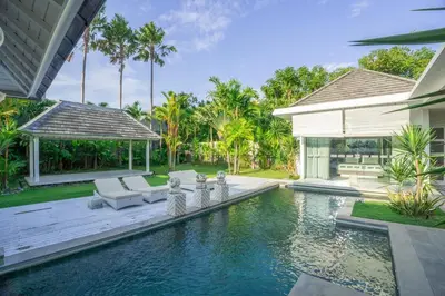 a house with a swimming pool next to a house at Bali Modern Escape With Private Pool, 8 guests in Kerobokan