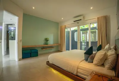 a bedroom with a large bed and a large window at Bali Modern Escape With Private Pool, 8 guests in Kerobokan