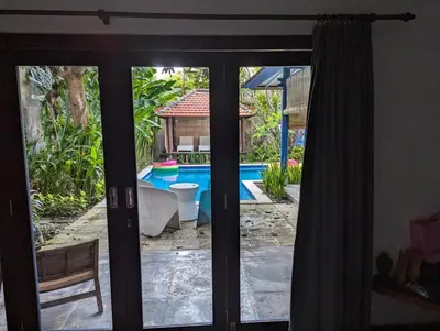 a view of a pool through a sliding glass door at Your Tropical Oasis Mason Villas Seminyak in Seminyak