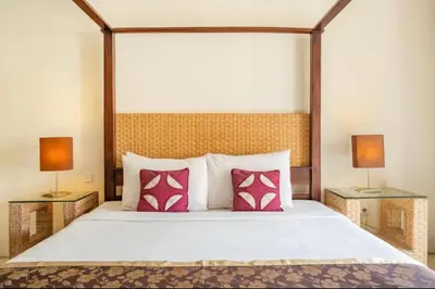 a bedroom with a large bed with two lamps at 4 Bedroom Private Villa Umalas 2 in Seminyak