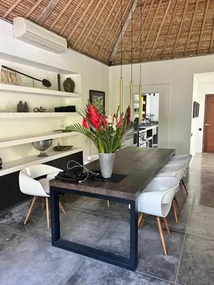 a dining room with a table and some chairs at Top Villa Ilo, best area near canggu 250 m2 on 750 m2 land in Kerobokan