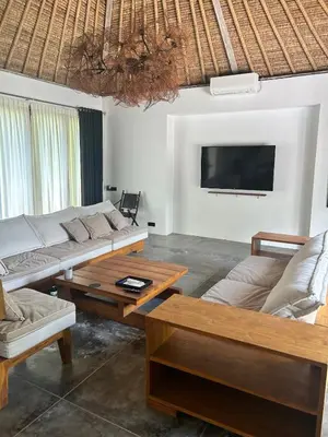 a living room with two couches and a flat screen tv at Top Villa Ilo, best area near canggu 250 m2 on 750 m2 land in Kerobokan