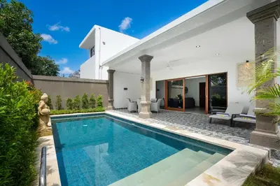 a swimming pool in the backyard of a house at Aster Villa by iBali Management in Legian