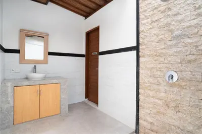 a bathroom with a sink and a shower at Melati Villa by iBali Management in Legian