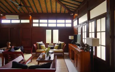 a large living room with couches and a tv at Oemah Djoglo Kerobokan in Kerobokan