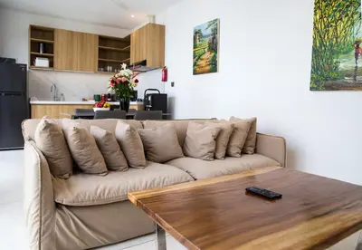 a living room with a couch and a wooden table at Villa Kumala Sari in Seminyak