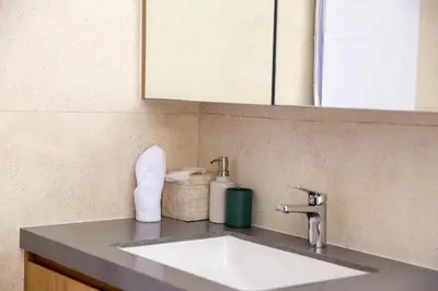 a bathroom counter with a sink and a mirror at Villa Kumala Sari in Seminyak