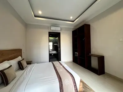 a bedroom with a bed and a ceiling at White Lotus Villa by Miel Property in Seminyak