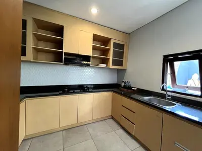 a kitchen with a sink and a window at Grand Kesambi Family Villa by Miel Property in Seminyak