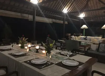 a table with candles and plates and glasses on it at Large Private Villa, central Seminyak, Bali in Seminyak