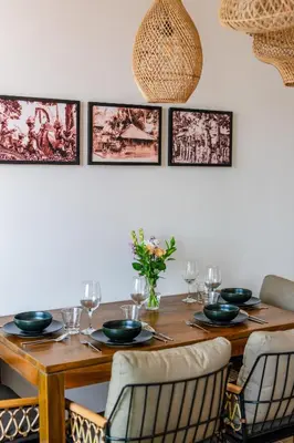 a dining room with a wooden table and chairs at Avanya Luxury Apartment by Pertama Management in Seminyak