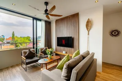 a living room with a couch and a tv at Avanya Luxury Apartment by Pertama Management in Seminyak