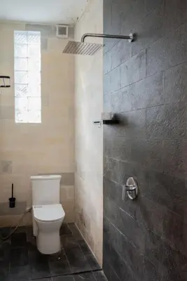 a bathroom with a toilet and a shower at Villa Manis with a private pool in Nusa Dua in Nusa Dua